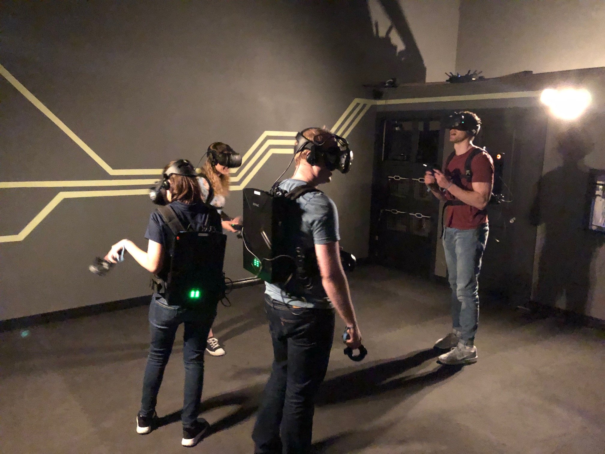 VR escape room players wearing equipment